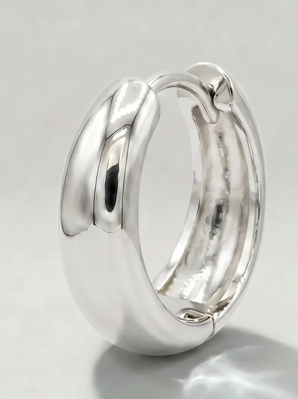 Silver huggie hoop close-up