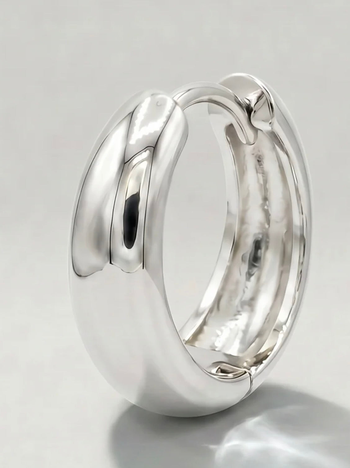 Silver huggie hoop close-up